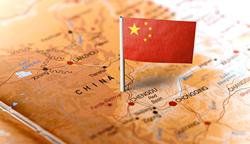 China flag pinned to China on a map