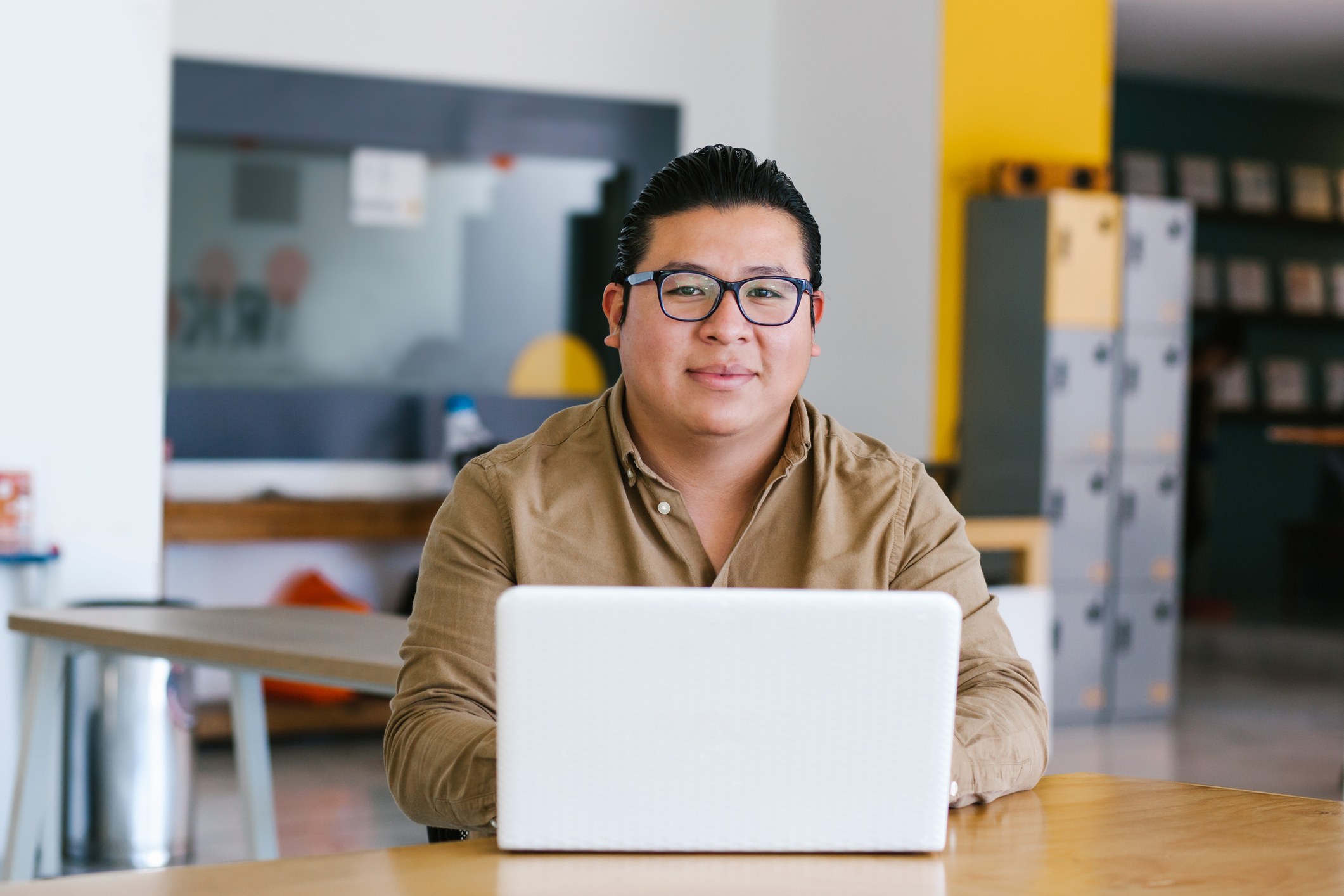 man at laptop looking at camera 