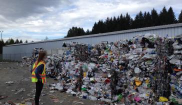 woman looking at a pile of recycling