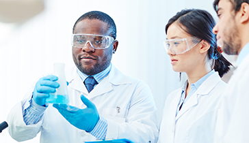 Researchers looking at test tube
