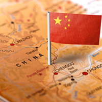 China flag pinned to China on a map