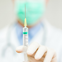 Close up of a doctor's hand holding a vaccine 