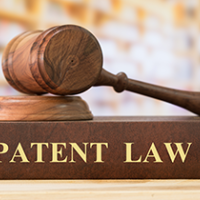 Gavel sitting on top of a book that reads PATENT LAW