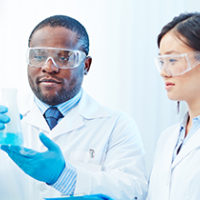 Researchers looking at test tube