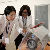 Women operating high tech lab equipment